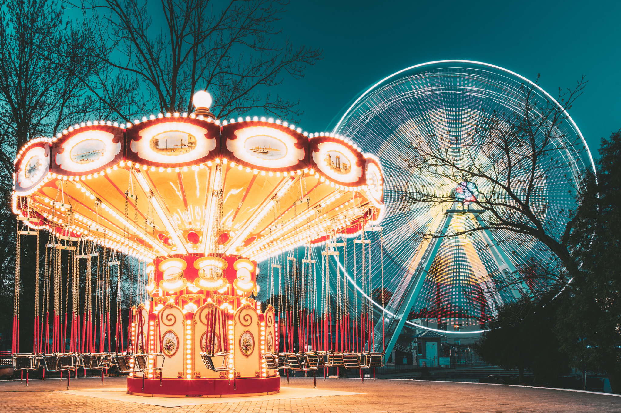 Amusement park rides lit up at night | Amusement park insurance