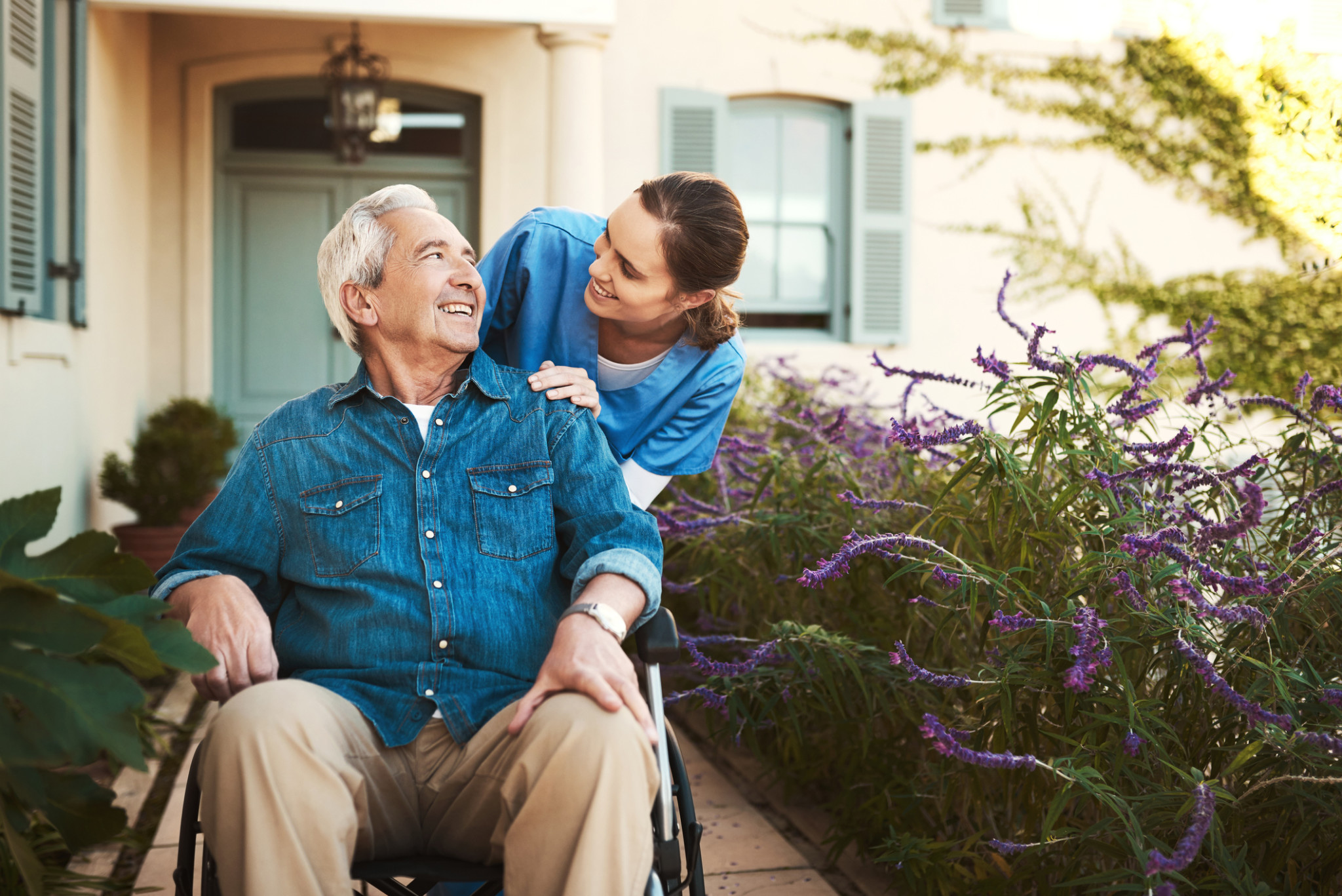 Nurse outside with a senior patient in wheelchair | Assisted living communities insurance