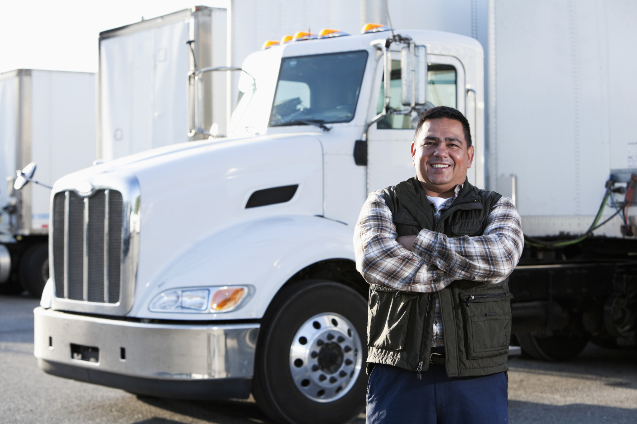 truck driver standing in front of semi truck cab